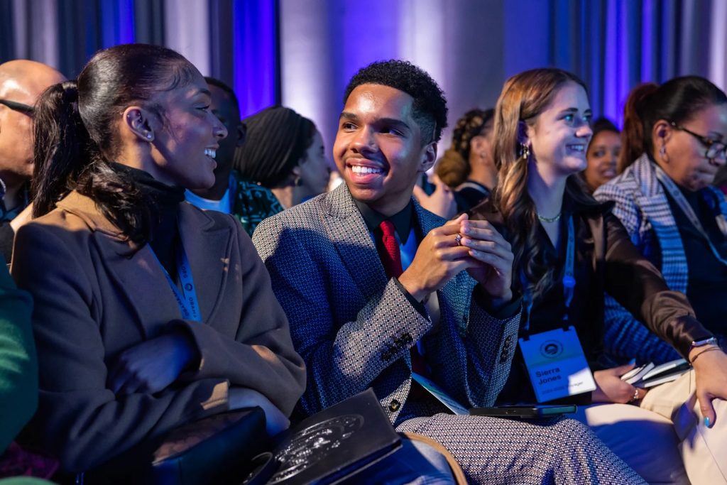 Photo of young men and women talking.